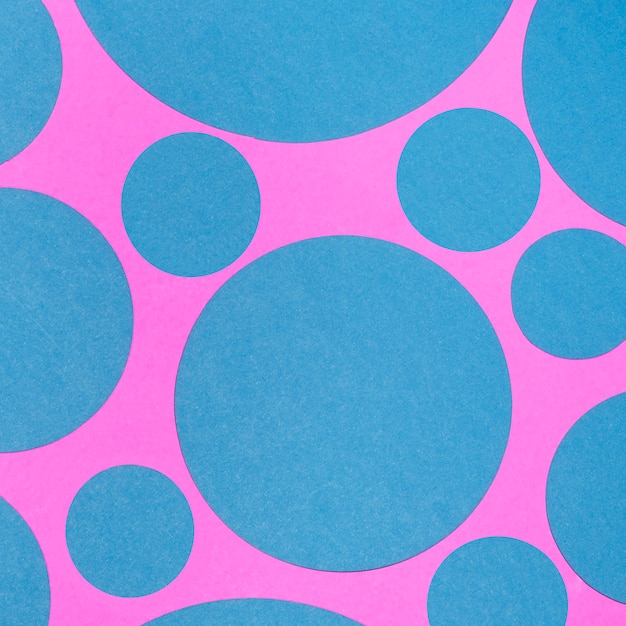 Blue seamless pattern of circles on pink backdrop