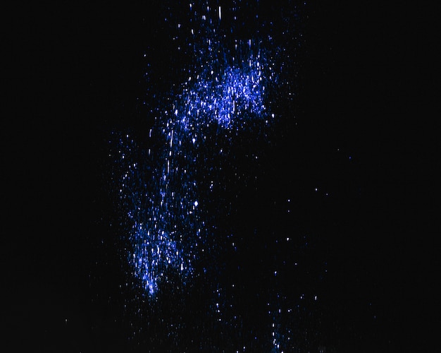 Blue sequins on dark background