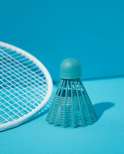 Blue shuttlecock and badminton racket