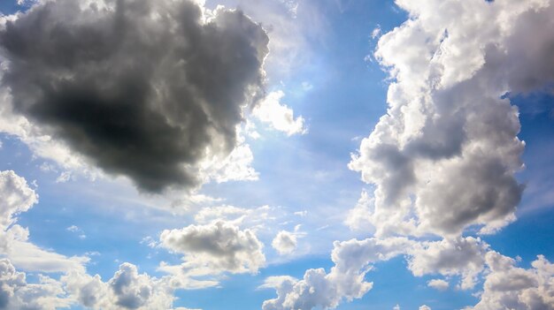 하얀 포동포동한 구름과 태양이 있는 푸른 하늘. 적운 구름. 자연 날씨 푸른 하늘입니다. 아름 다운 배경 흰 구름입니다.