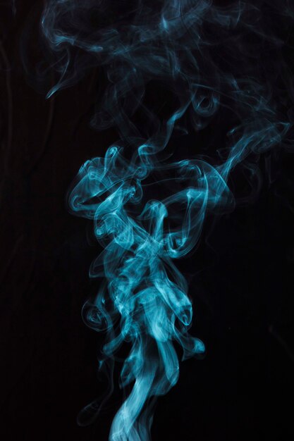 Blue smoke on black background with copy space for writing the text