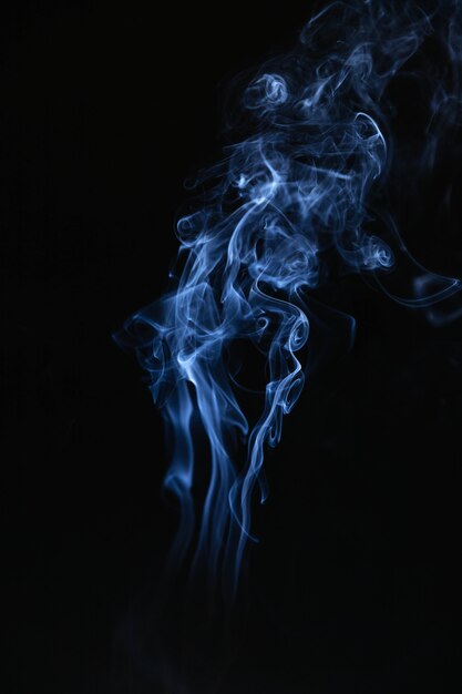 Blue smoke waves on black background