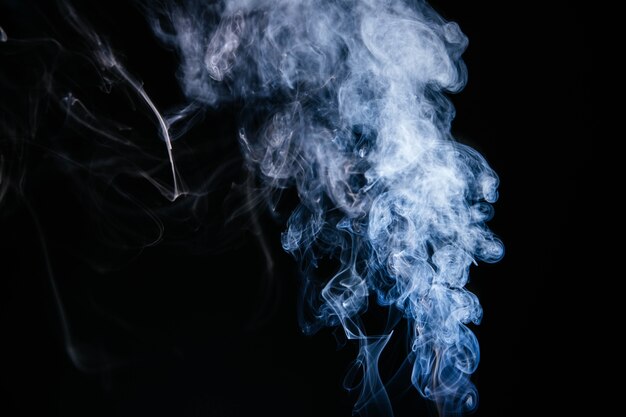 Blue smoke waves on black background