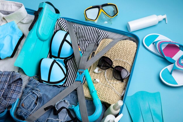 Blue suitcase with travel paraphernalia