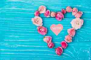 Free photo blue surface with floral heart for mother's day