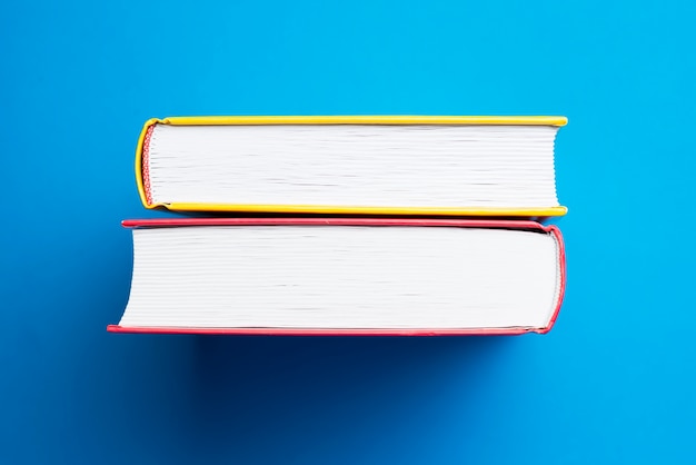 Free photo blue surface with yellow and red books