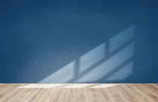 Free photo blue wall in an empty room with wooden floor