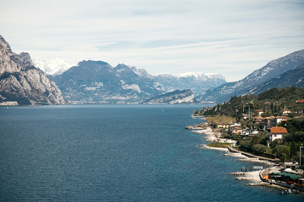 Blue water at the beaches of Verona and gorgeous mountains