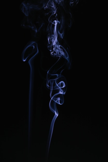 Blue wavy smoke on black background