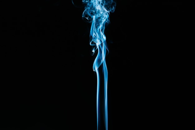 Blue wavy smoke on black background