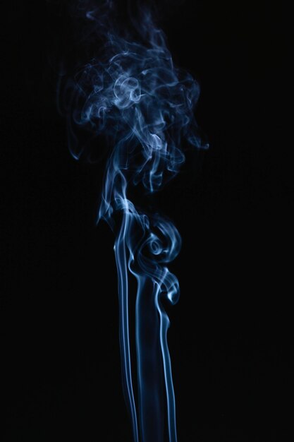 Blue wavy smoke on black background