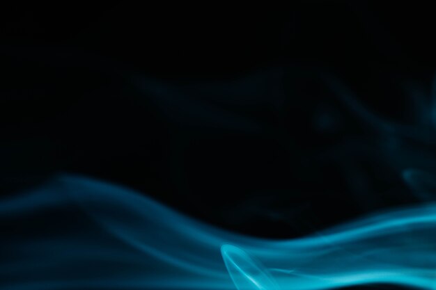 Blue wavy smoke on black background