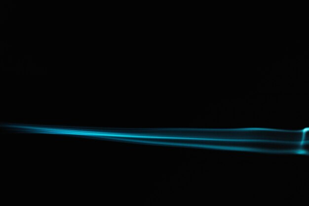 Blue wavy smoke on black background