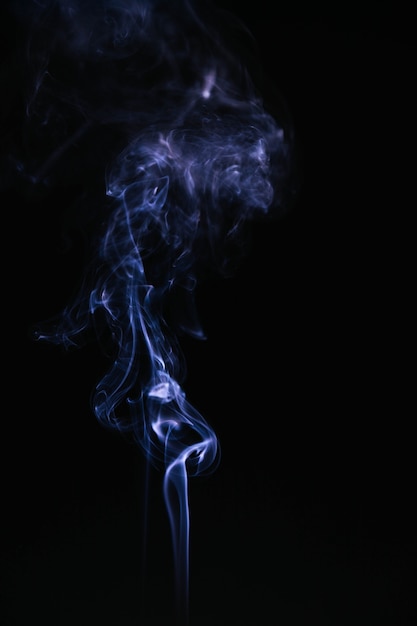 Free photo blue wavy smoke on black background