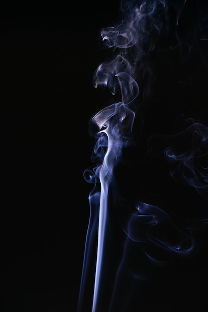 Blue wavy smoke on black background