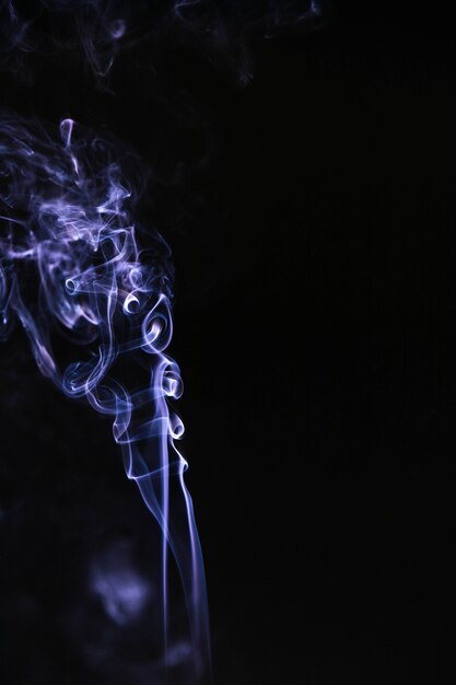 Blue wavy smoke on black background