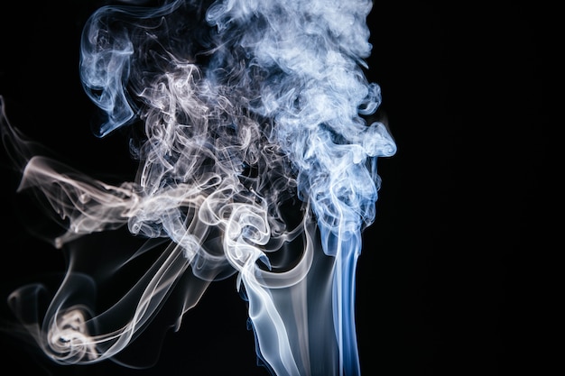 Free photo blue wavy smoke on black background