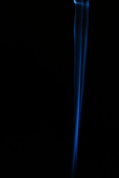 Blue wavy smoke on black background