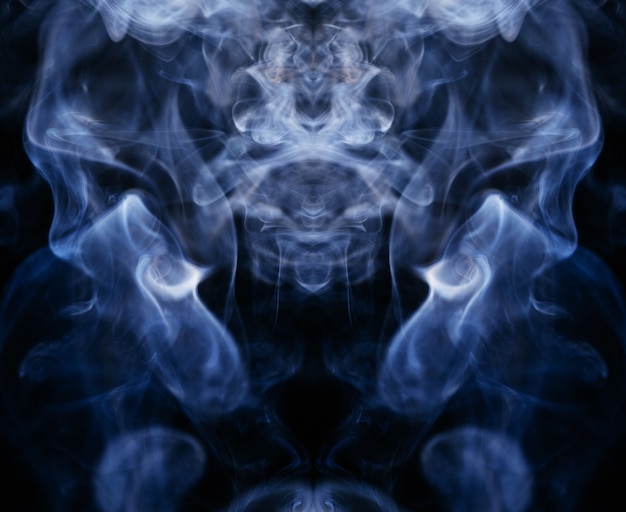 Free photo blue wavy smoke on black background