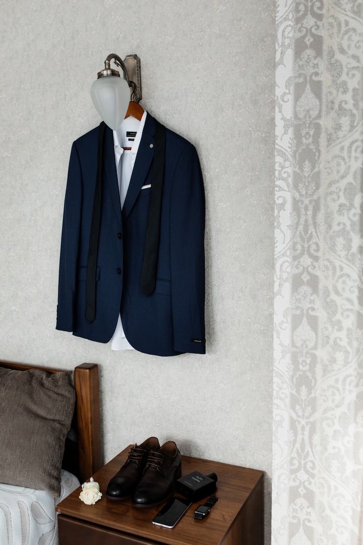 Free Photo blue wedding attire for a groom hanging on the wall
