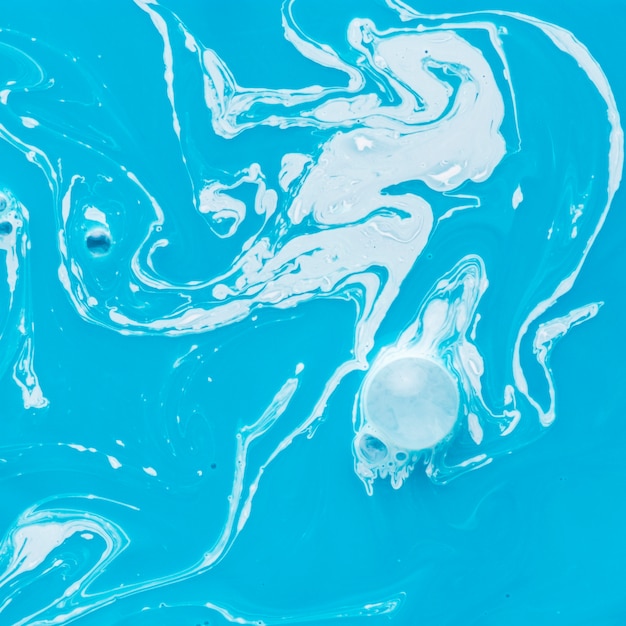 Blue and white liquid paint swirl texture background