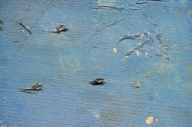 Blue wood with nail marks