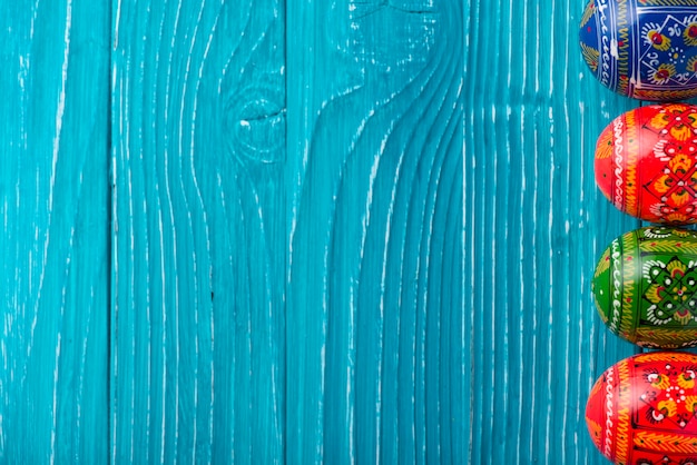 Blue wooden background with easter eggs