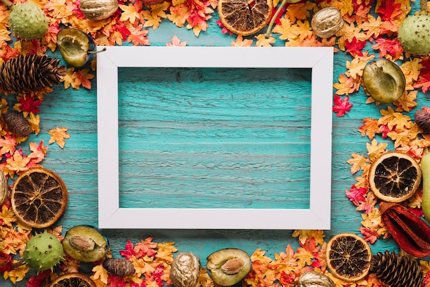 Blue wooden background with leaves, harvest and frame picture