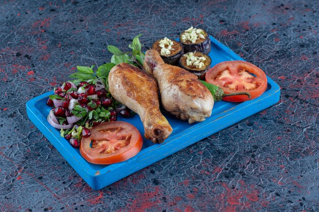 A blue wooden board of grilled chicken meat