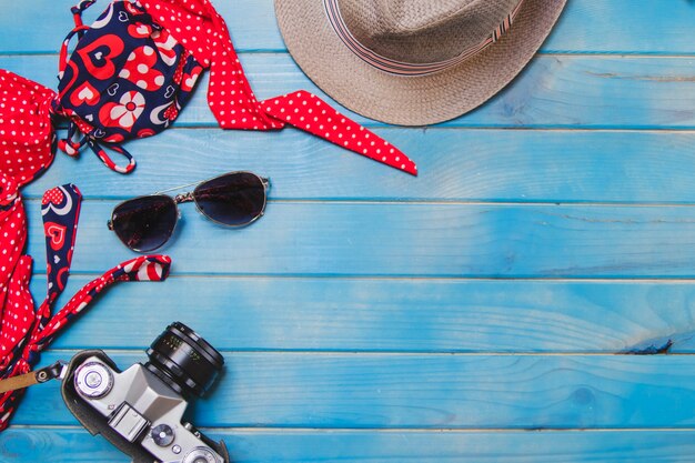 Blue wooden surface with bikini and other summer elements