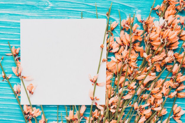 Blue wooden surface with note and floral decoration