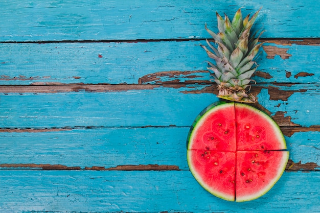 Blue wooden surface with watermelon portions