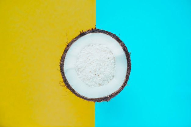 Blue and yellow background with half coconut