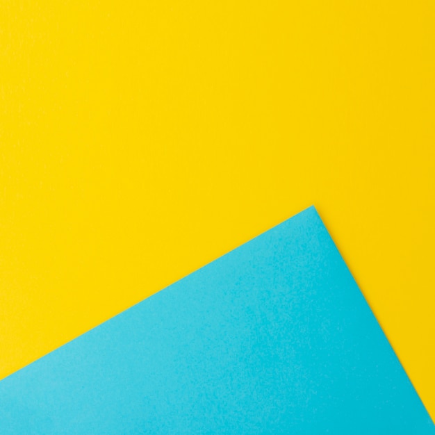 Free photo blue and yellow paper sheets with copy space