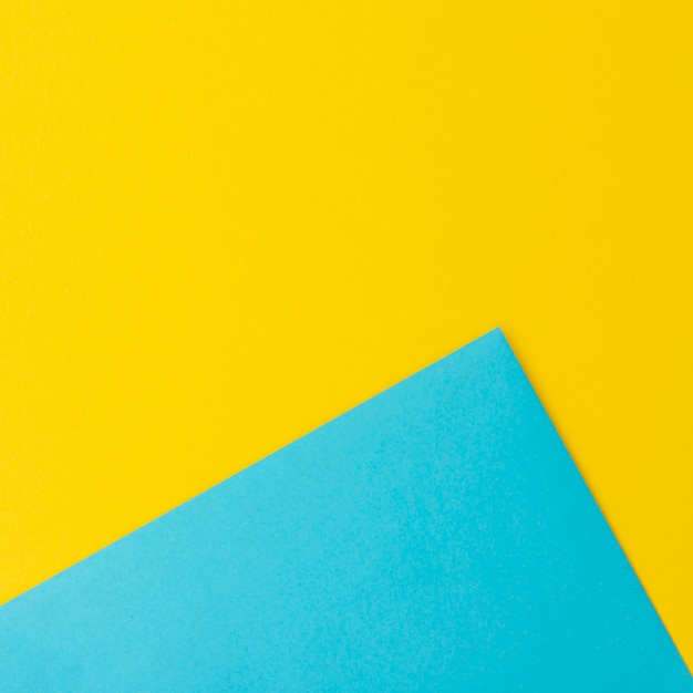 Blue and yellow paper sheets with copy space