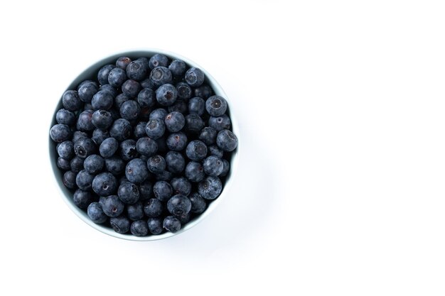 Blueberries in green bowl isolated on white background