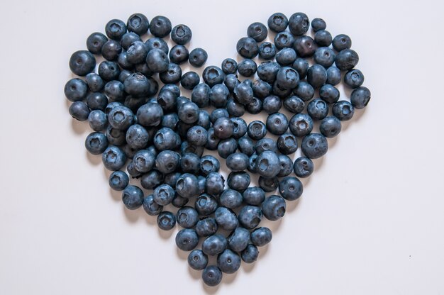 Blueberries isolated on white background. Blueberry border design. Ripe and juicy fresh picked bilberries close up. Copyspace. Top view or flat lay