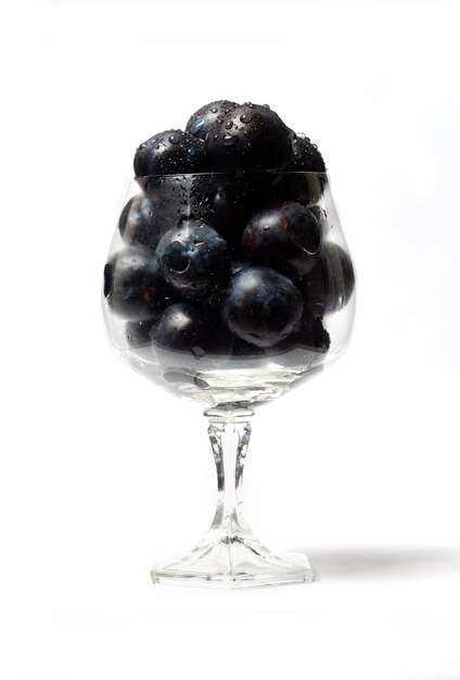 Blueberries in a wine glass isolated on white