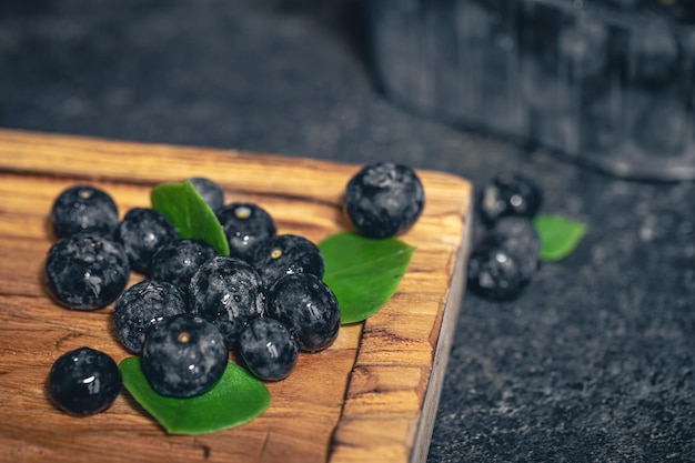 Free photo blueberry berries closeup on a dark blurred background