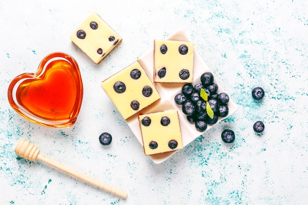 Blueberry cheesecake bars with honey and fresh berries.