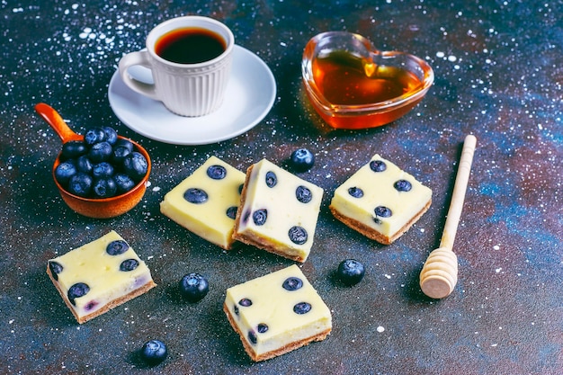 Blueberry cheesecake bars with honey and fresh berries.