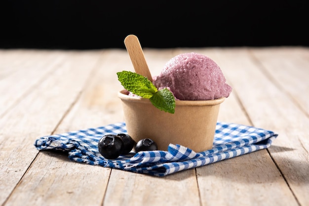 Blueberry ice cream scoop on wooden table