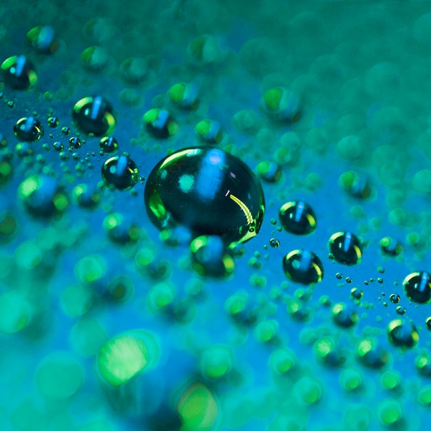 Free photo blur green bokeh with water drop on the surface