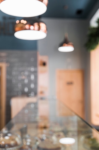 Blur interior of coffee shop with lighting equipment