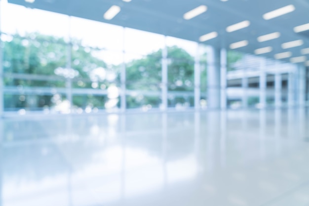 Blurred abstract background interior view looking out toward to empty office lobby and entrance doors and glass curtain wall with frame