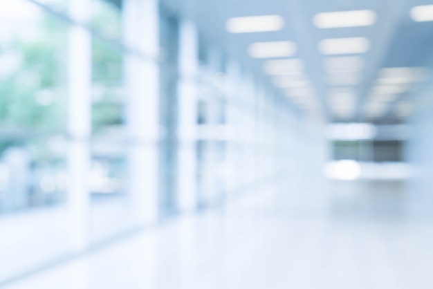 Blurred abstract background interior view looking out toward to empty office lobby and entrance doors and glass curtain wall with frame