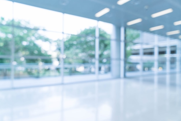 Blurred abstract background interior view looking out toward to empty office lobby and entrance doors and glass curtain wall with frame