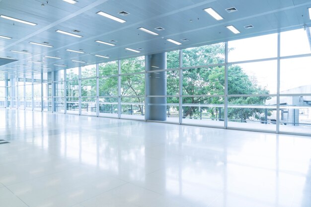 Blurred abstract background interior view looking out toward to empty office lobby and entrance doors and glass curtain wall with frame