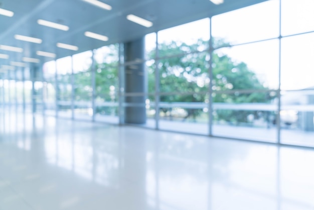 Free photo blurred abstract background interior view looking out toward to empty office lobby and entrance doors and glass curtain wall with frame