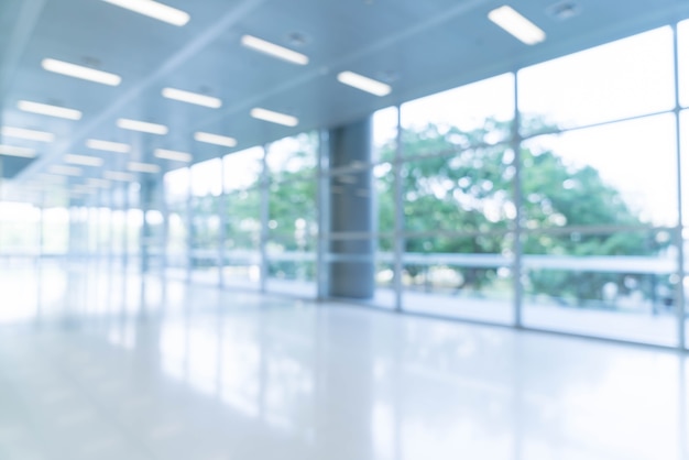 Blurred abstract background interior view looking out toward to empty office lobby and entrance doors and glass curtain wall with frame